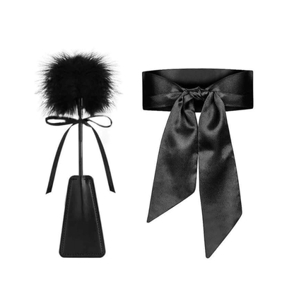 Black feather tickler and satin blindfold for enhancing intimate experiences and exploring desires.